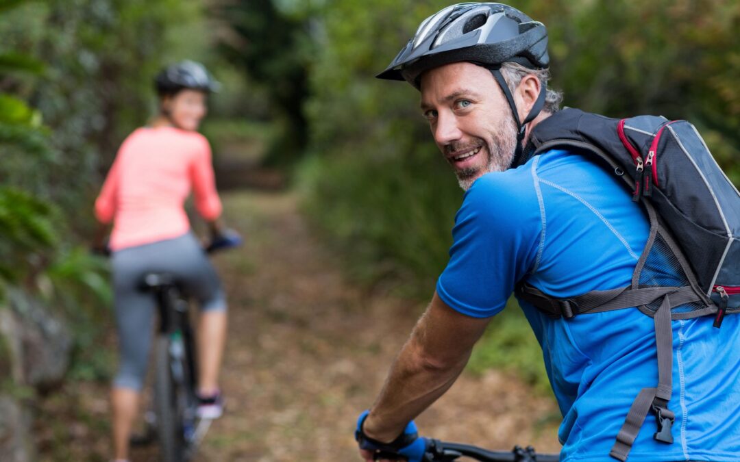 athletic-couple-cycling-in-forest-DBE5267