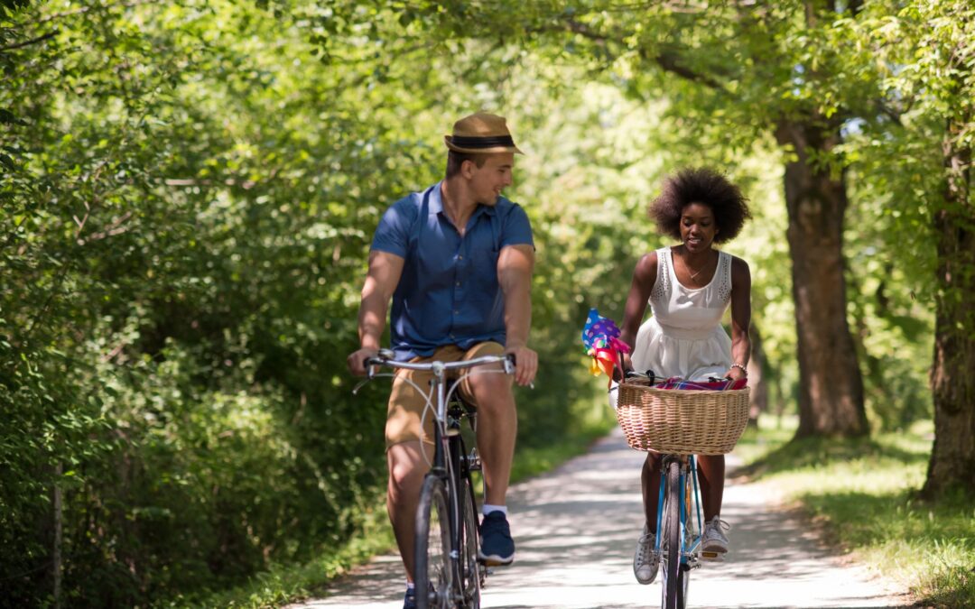 young-multiethnic-couple-having-a-bike-ride-in-nat-P75RRK3